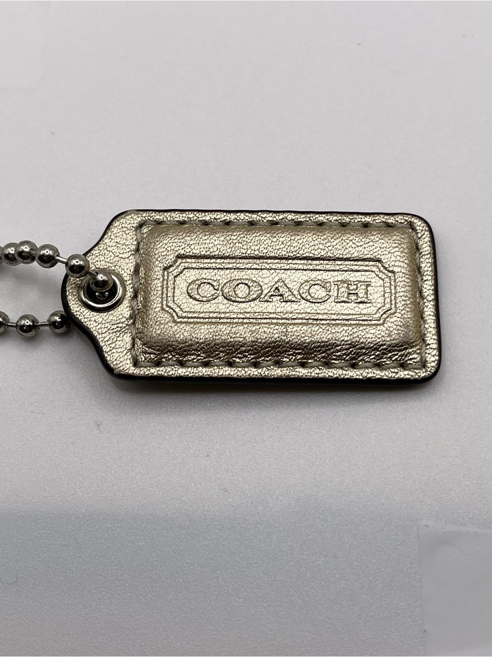 Coach Poppy Metallic SILVER Leather Hang Tag
